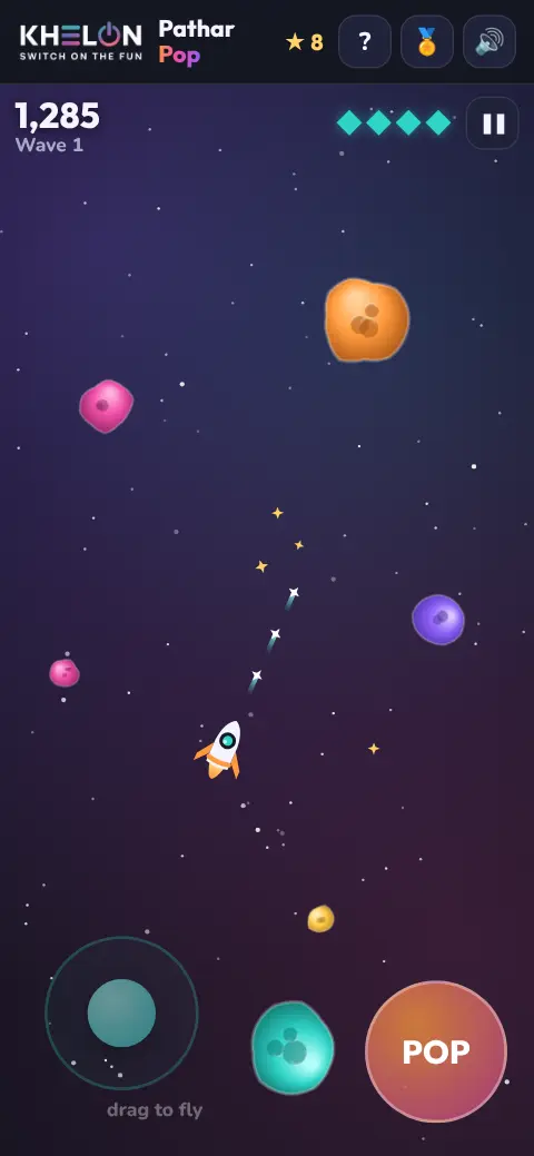 A Pathar Pop game on a phone: a small white rocket sends sparkles at colourful rocks, with stardust floating nearby
